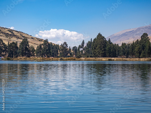 Landscape of beautiful lake with relfection with mountains and trees in natural park Huancayo, peru photo