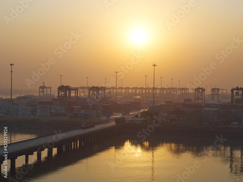 India, Mumbai Port Trust - 25 January, 2017: View to stored container during the morning sunrise.