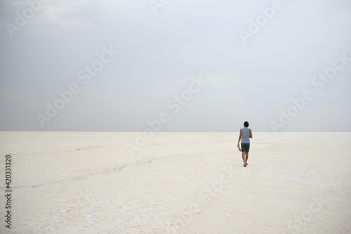 person walking in a salt desert