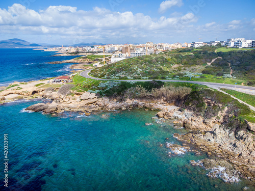 Aerial view of Alghero southern shore under a cloudy sky photo