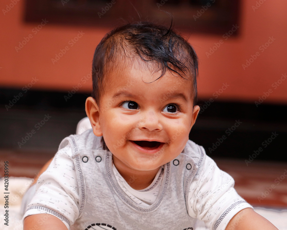 6 months cute indian baby boy lying on a soft baby towel with smile Stock  Photo | Adobe Stock