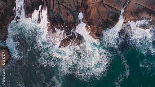 Ocean waves hit the rock formation of sea coast. Beautiful nature footage took with drone. 4K, 30fps