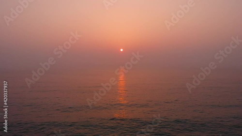 Sunrise at the east ocean with red glow sky. beautiful nature moment took with drone. 4K 30fps 
