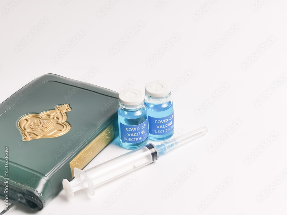Selective focus image Covid 19 vaccines,syringe,Holy Quran with arabic