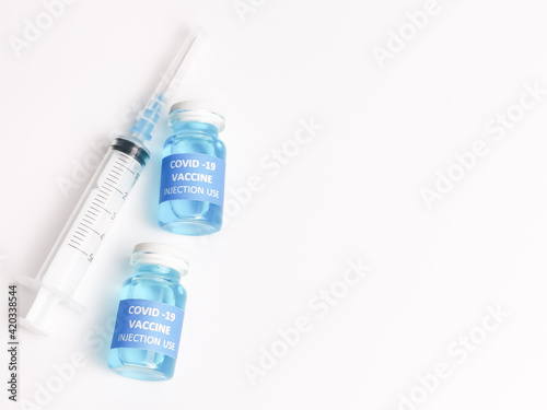 Selective focus COVID 19 VACCINE with syringe isolated on white background. 