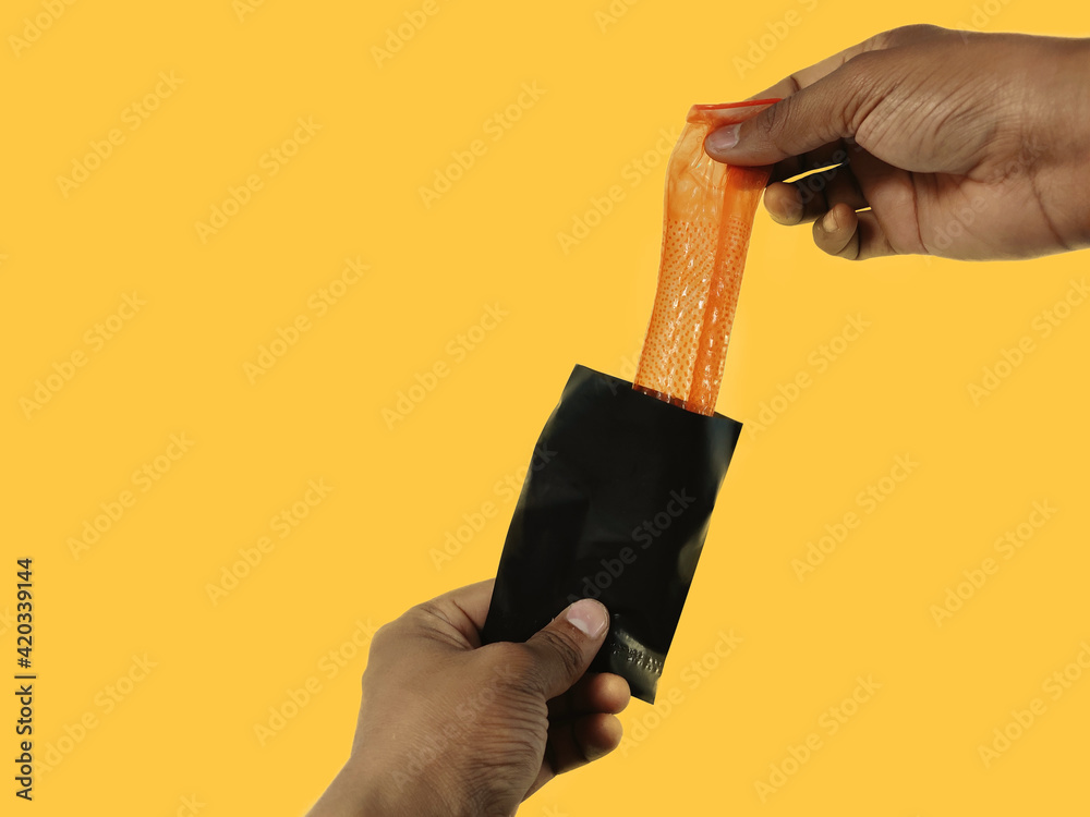 Condom disposal sachet used after sex for dispose off Condom, hand holding and keeping inside