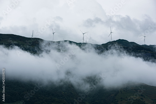 Wind turbines in the clouds on top of the mountain