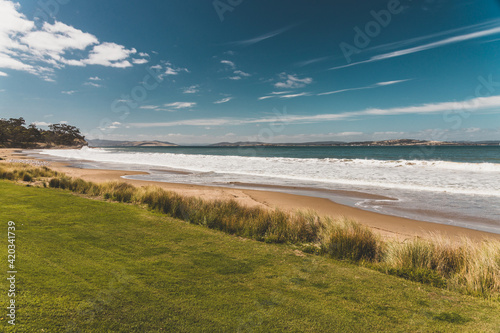 Bllackmans Bay beach in southern Hobart in Tasmania, Australia on a very windy day with intense swell and waves and no people