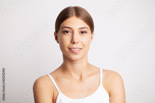 Partial portrait of girl with strong white teeth looking at camera and smiling