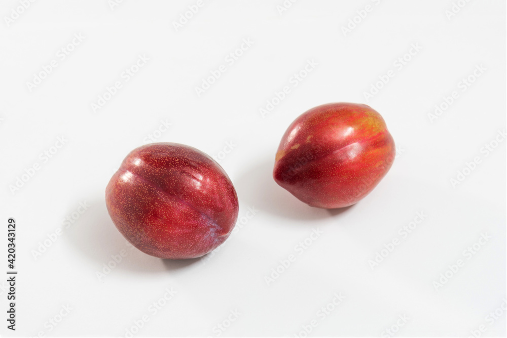 Fototapeta premium red plums isolated on white background