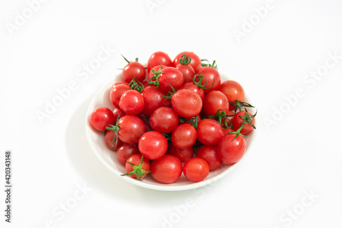 A saucer of cherry tomatoes isolated on white background