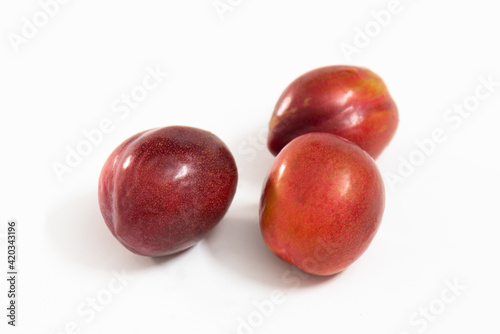 red plums isolated on white background