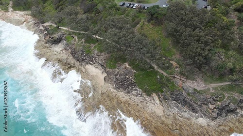 Ocean Waves Crashing At Cylinder Headland Foreshore - Coastal Walk Near Cylinder Beach In Point Lookout, North Stradbroke Island, QLD, Australia. - aerial photo