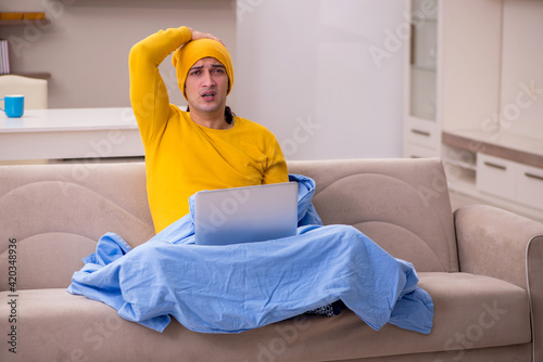 Young man freelancer suffering at home
