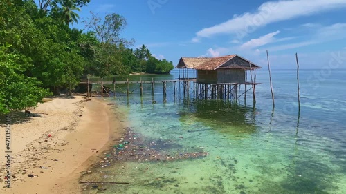 Plastic trash floating on the ocean coast near a lush forest. Beautiful beach landscape polluted photo