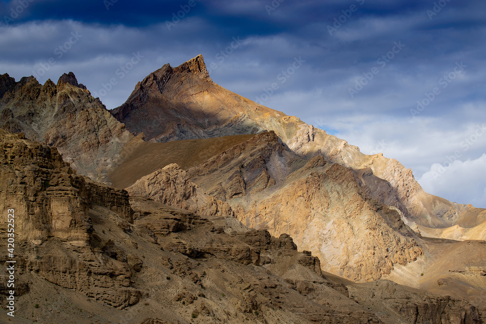 Rocky Himalayan mountian landscape of Kargil with blue cloudy sky in background , green valley , Ladakh, Jammu and Kashmir, India