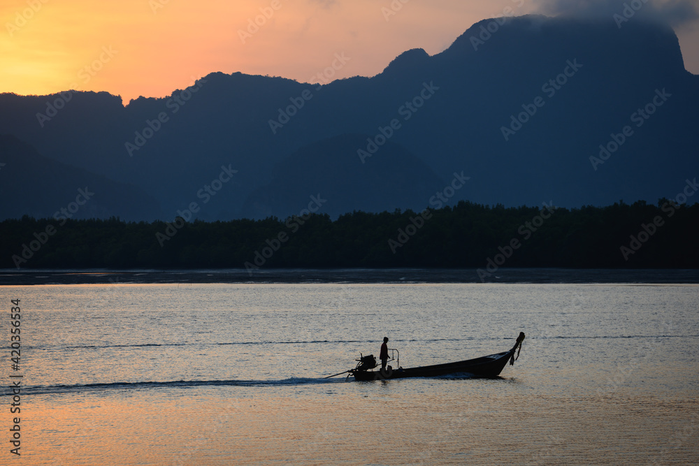 Villager riding a boat at Phuket, Thailand
