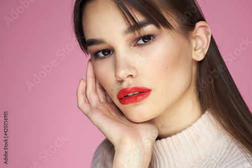 Beautiful brunette red lips white blouse close-up attractive view pink background