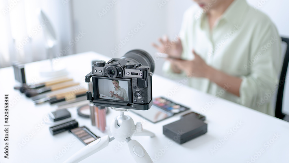 Female beauty blogger Influencer filming cosmetics makeup or comparing review on live stream.. Female beauty blogger Influencer filming cosmetics makeup or comparing review on live stream..