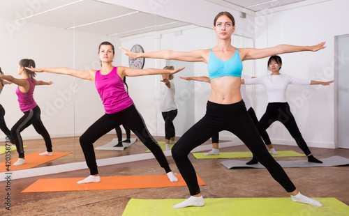 Women doing stretching exercises for yoga in the room. High quality photo