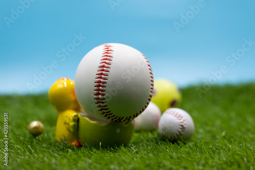 Baseball for Easter Holiday with Easter eggs on green grass