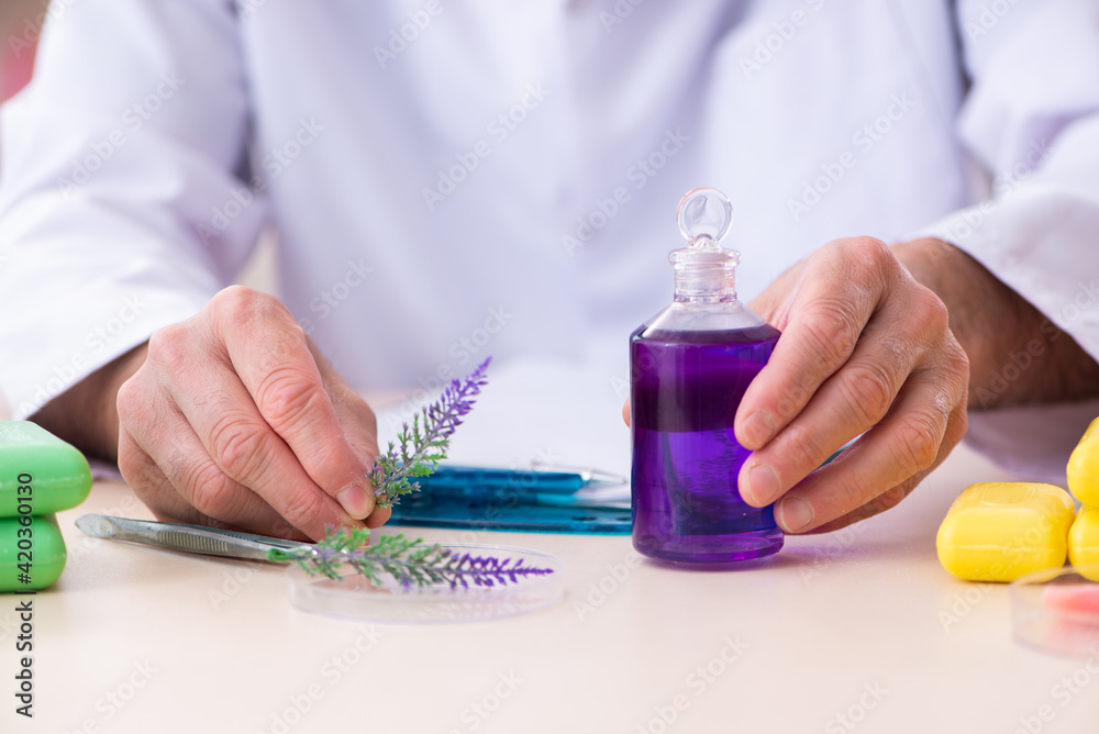 Old male chemist testing soap in the lab Old male chemist testing soap in the lab