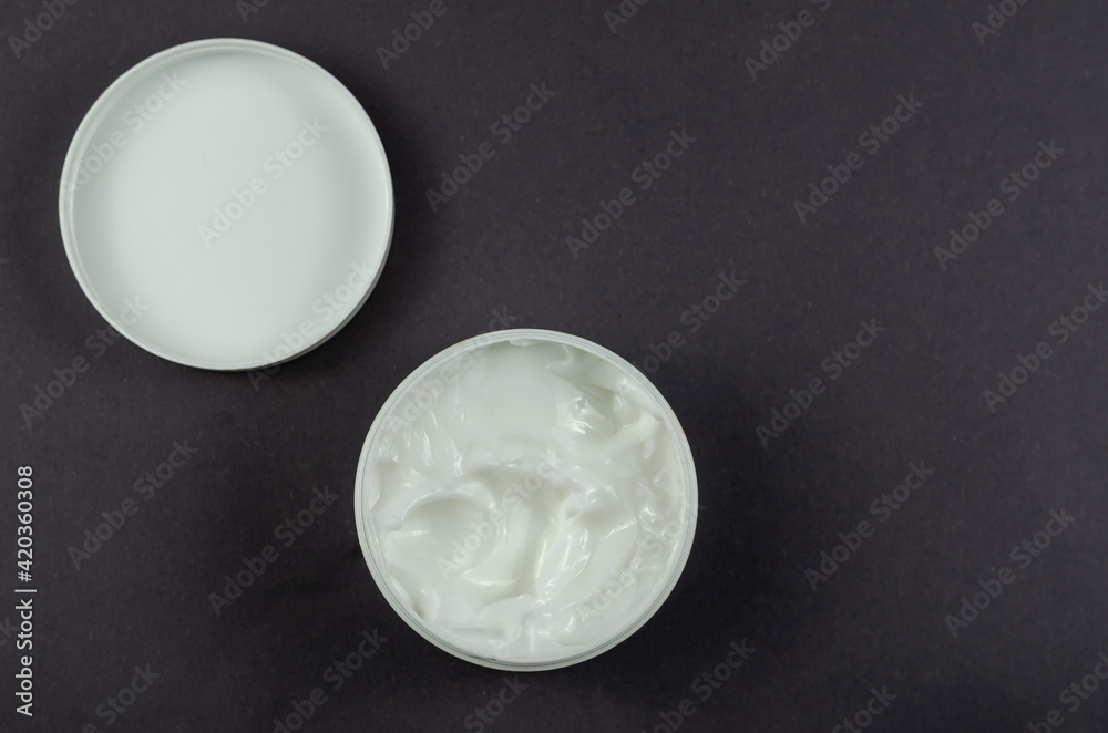 Cosmetic cream container on gray background. Cosmetic cream container on gray background.
