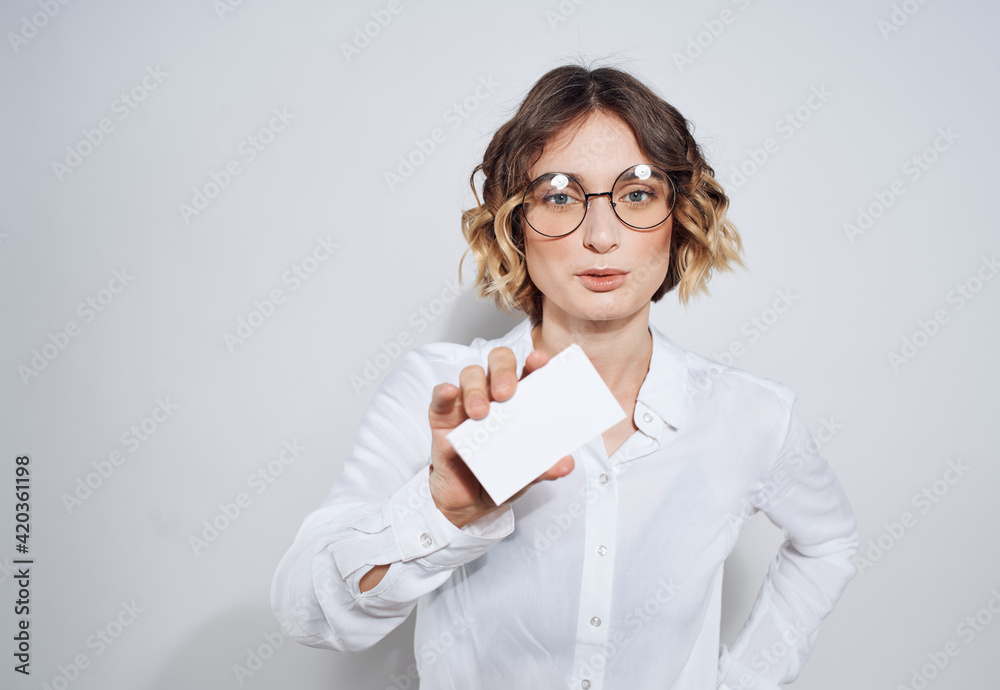 Business woman with a business card on a light background work advertisement Business woman with a business card on a light background work advertisement