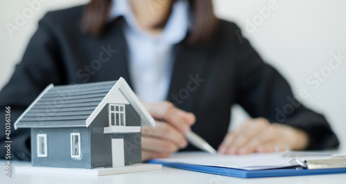 agents working in real estate investment and home insurance signing contracts in accordance with the home buying insurance agreements approving purchases for clients