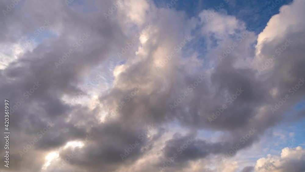 Timelapse colorful dark clouds in sunset time Beautiful light of nature Amazing colors of the setting sun Majestic clouds flowing in sunset sky Evening dark clouds,day to night 4-K Time Lapse Cloudsca