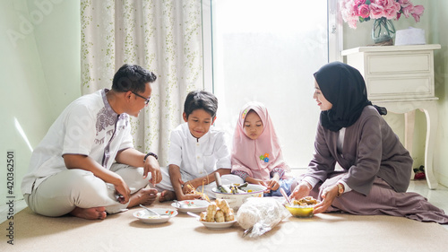 The family tradition of Eid al-Fitr is to eat ketupat opor or side dishes