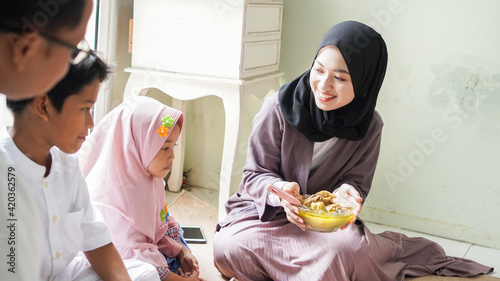 The family tradition of Eid al-Fitr is to eat ketupat opor or side dishes photo