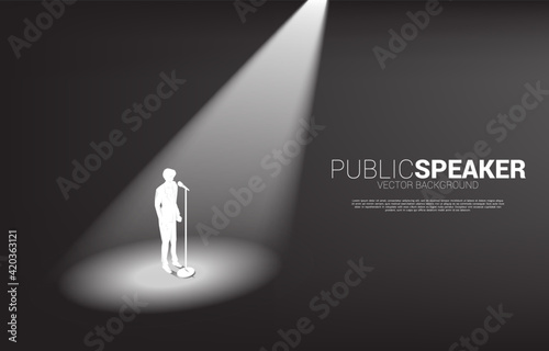 Silhouette of businessman standing with microphone. Concept of front man and public speaking.