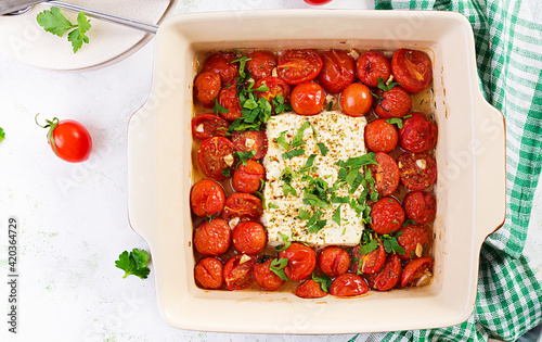 Preparation of ingredients for fetapasta. Trending Feta bake pasta recipe made of cherry tomatoes, feta cheese, garlic and herbs.  Top view, above, copy space. photo