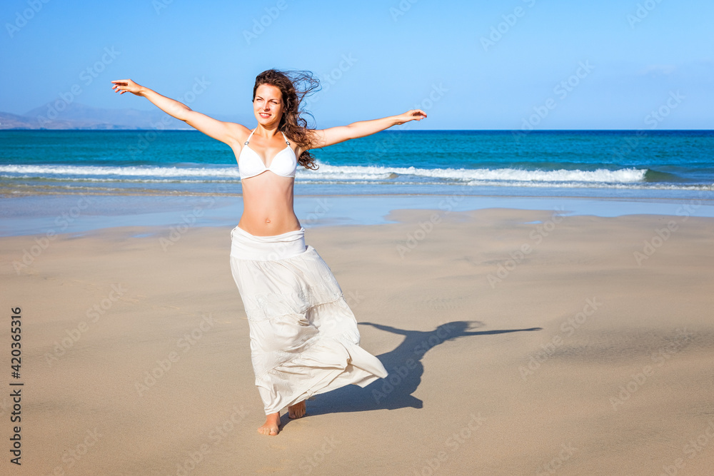 Attractive young woman enjoying the ocean beach on Fuerteventura Attractive young woman enjoying the ocean beach on Fuerteventura