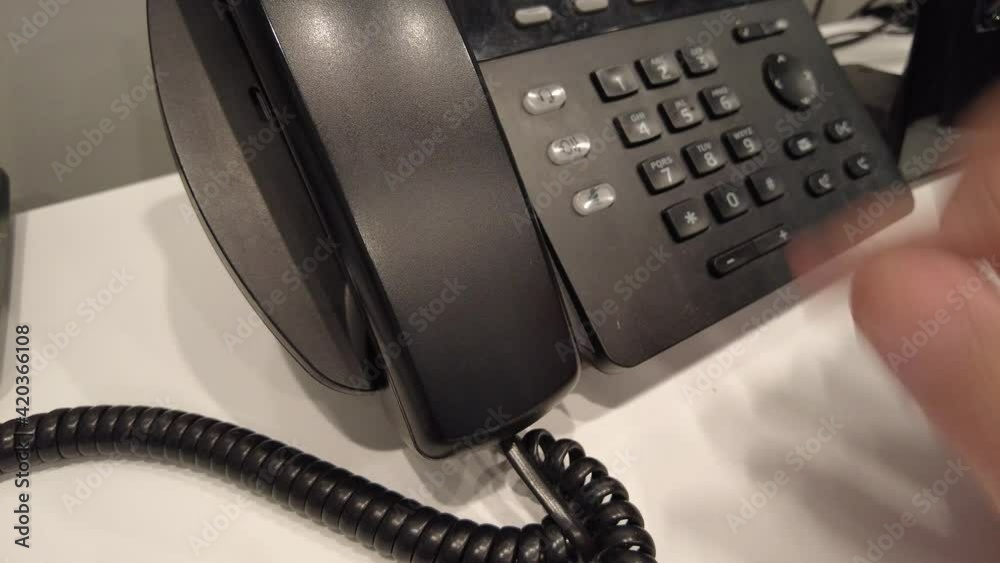 Dialing the phone at work to make a call to the company. Dialing the phone at work to make a call to the company.