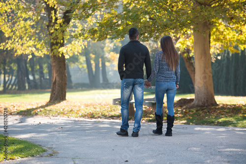 Lovers Walking Hand In Hand In Autumn Park