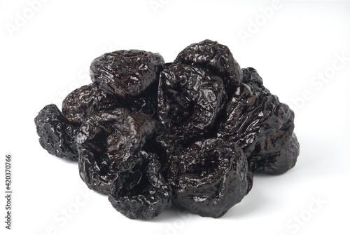 Heap of dried prunes isolated on white background