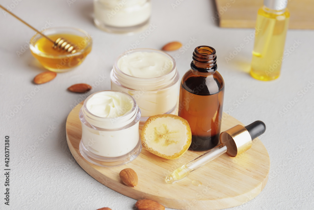 Composition with banana cosmetics on light background Composition with banana cosmetics on light background