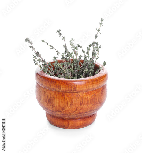 Mortar with thyme on white background