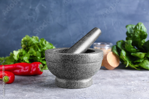 Fototapeta Naklejka Na Ścianę i Meble -  Mortar with spices and pestle on grey background
