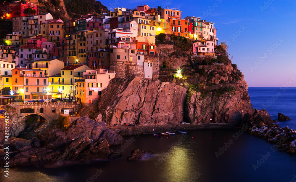 The colorful houses of Manarola, La Spezia in evening from sea view at Italy