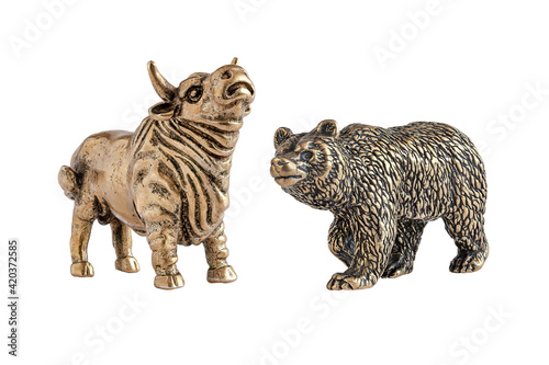 Isolated image of yellow metal bull and bear figurines. The concept of the symbol of stock trading, the interaction of buyers and sellers. A series of images. © mangz