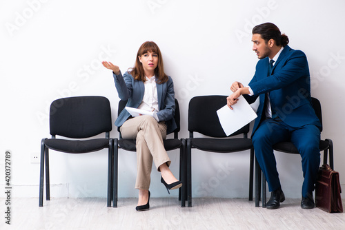 Young businessman and businesswoman waiting for an interview at