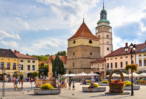 Panoramic view of market square with historic stone bell tower and Cathedral of Nativity of Blessed Virgin Mary in Zywiec, Silesia region of Poland