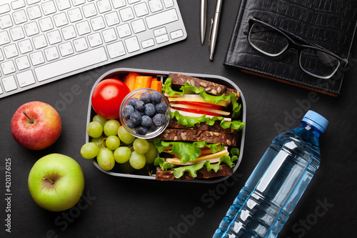 Quadro su tela Healthy office lunch box with sandwich and fresh vegetables