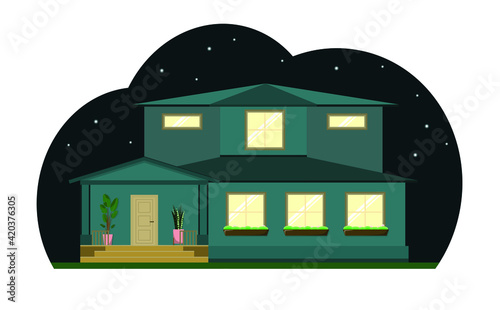 Cute two-story house at night. Country house, light in the windows