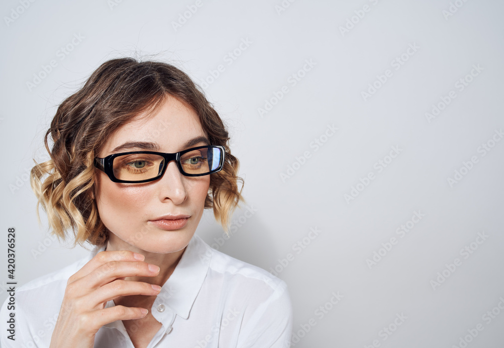 Woman wearing glasses with curly hair white shirt Copy Space