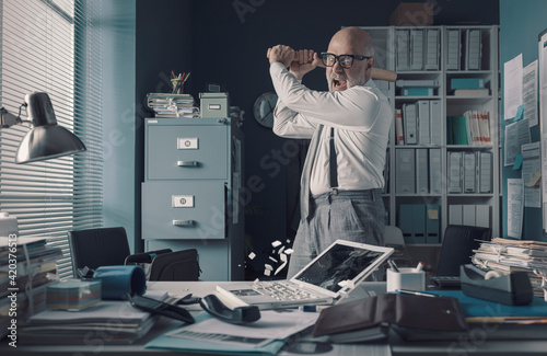 Konstfotografi Crazy businessman destryoing his office with a baseball bat