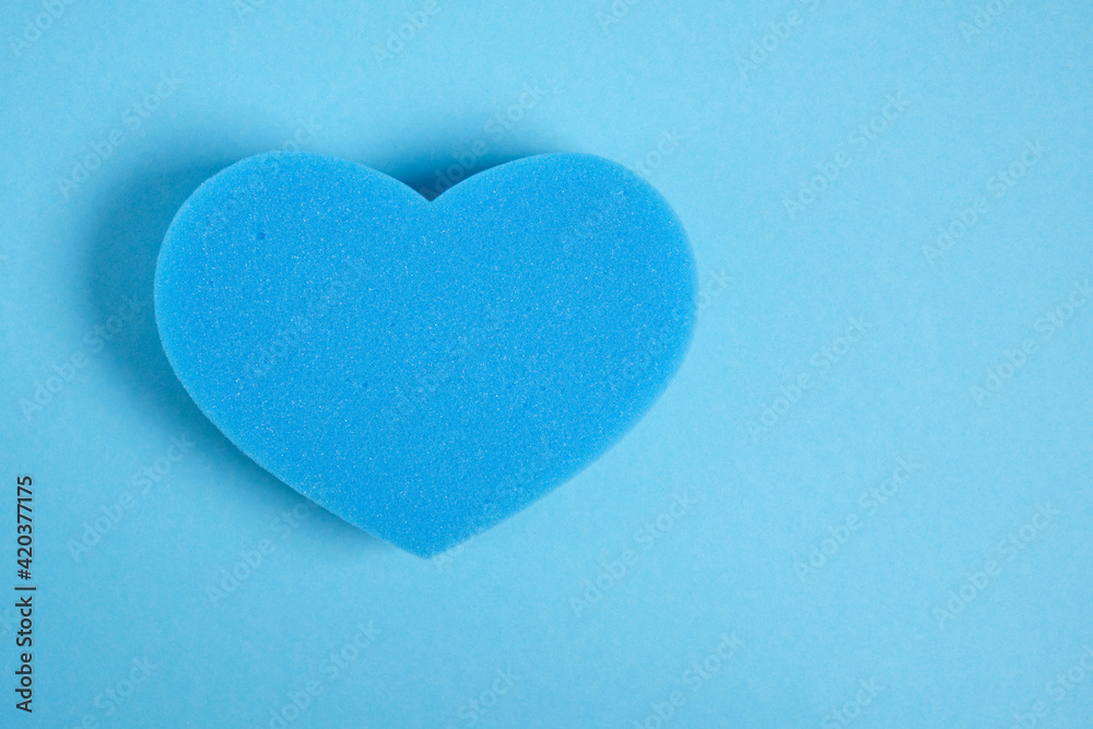 heart shape sponge on blue background copy space heart shape sponge on blue background copy space
